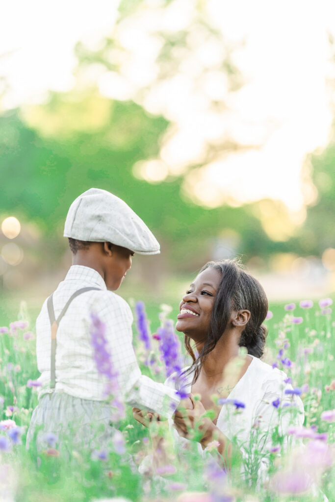 Mother and son gazing at each other lovingly amongst the wildflowers of Richardson, TX