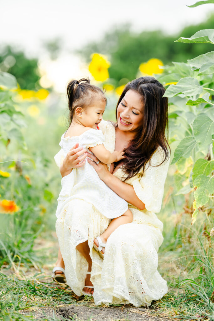 Joyful summer family portraits in sunflower field at The Little Sunflower Farm near Dallas
