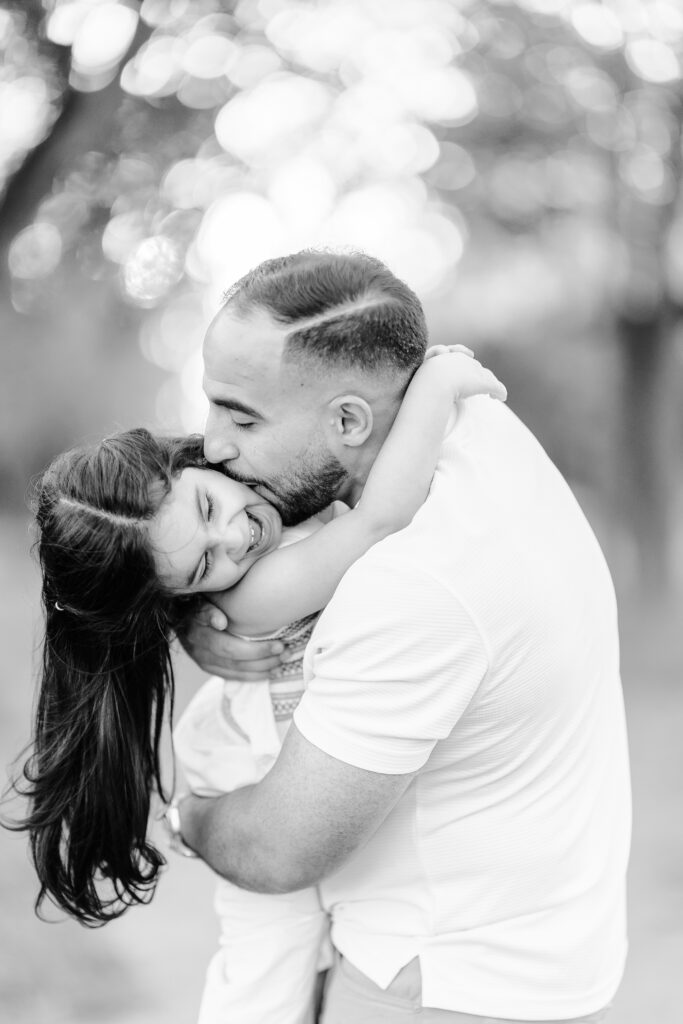 Father embracing his daughter in a quiet, emotional moment—timeless black-and-white portrait capturing love and connection.