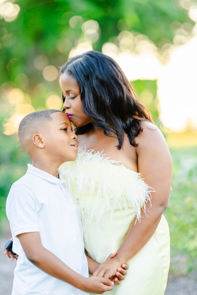 A tender moment between mother and son during an outdoor Frisco family photography session filled with soft light and emotion.