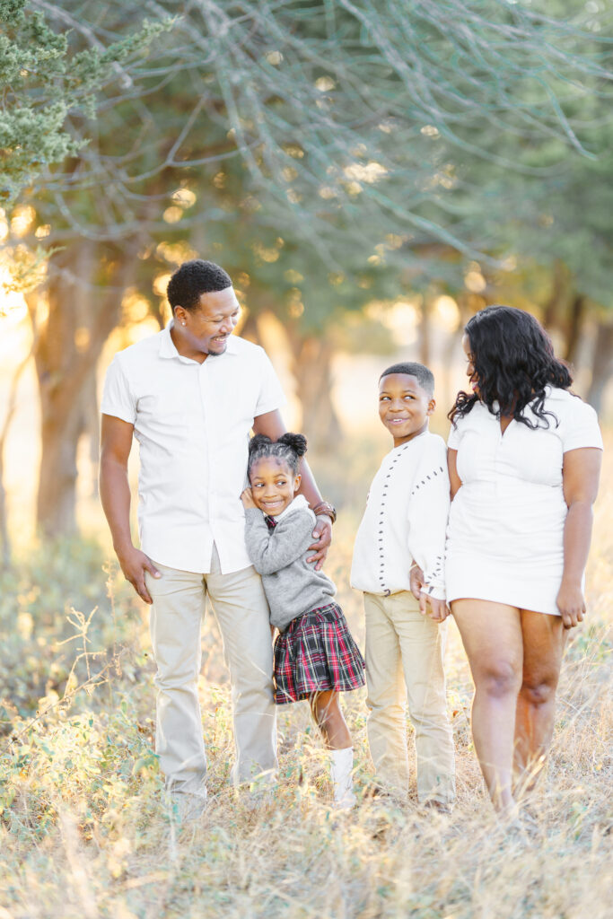 Family walking and sharing a moment of joy during a golden hour lifestyle photo session in Mckinney