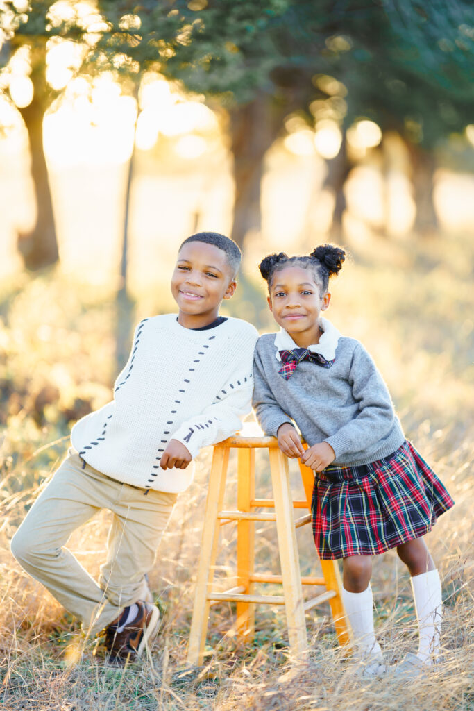 Brother and sister smiling during a relaxed outdoor family photo session in McKinney, Texas